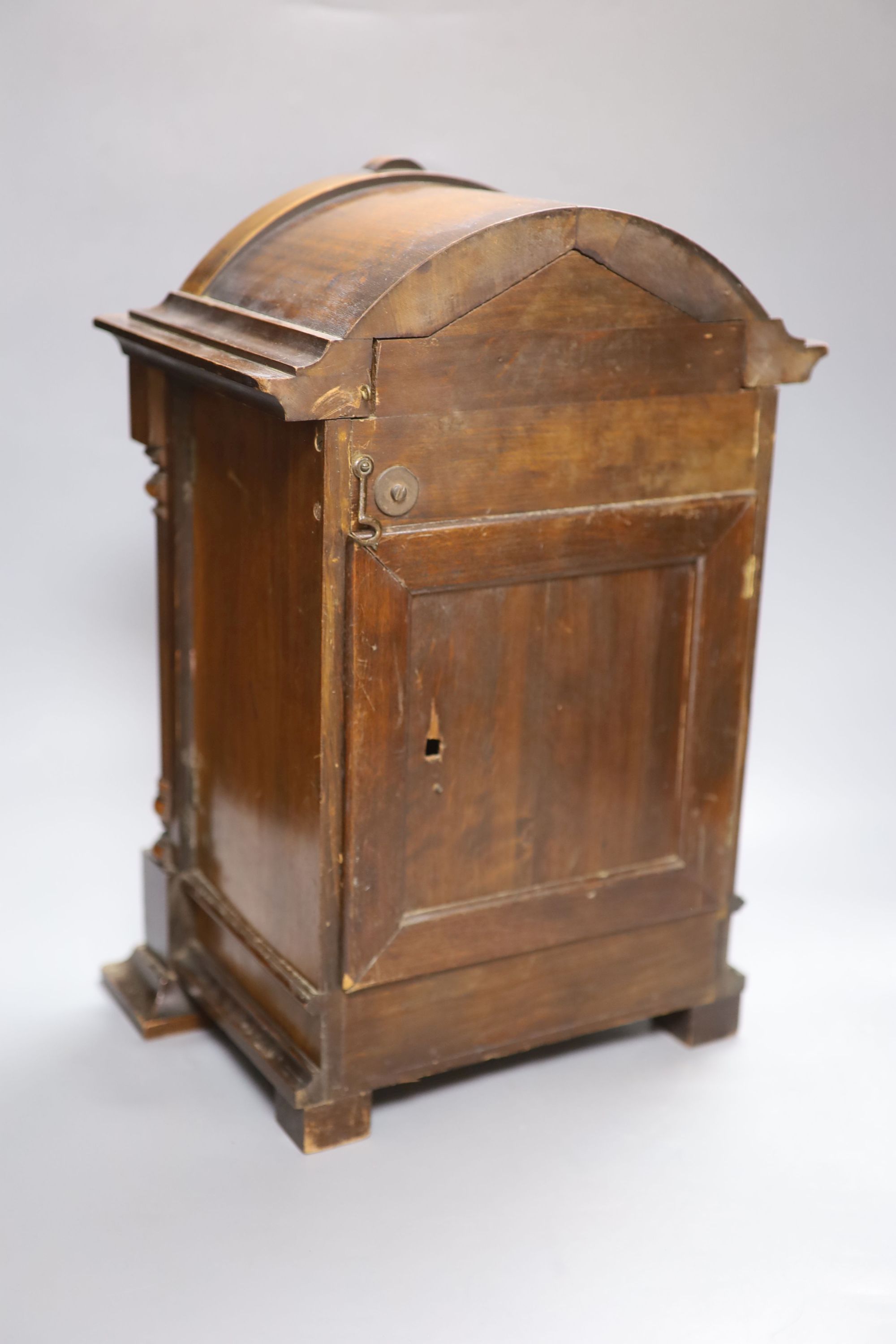 A German walnut mantel clock, converted to electric regulation, height 44cm